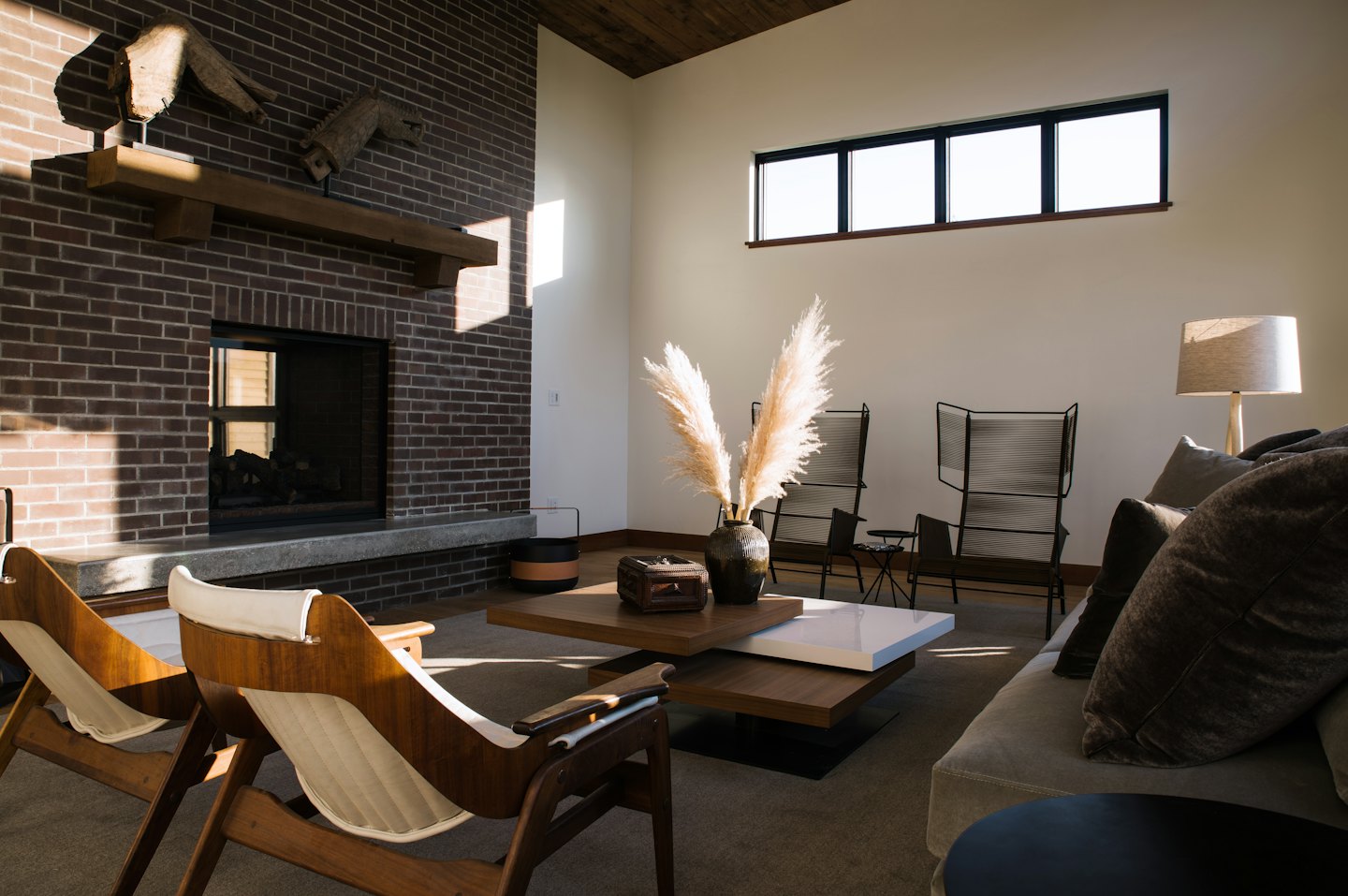 Modern living room featuring a brick fireplace and comfortable furniture.