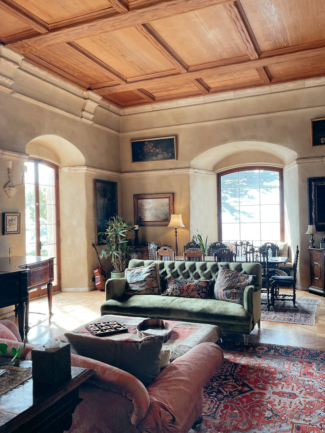 Olive green sofa and velvet armchair in a luxurious living room.